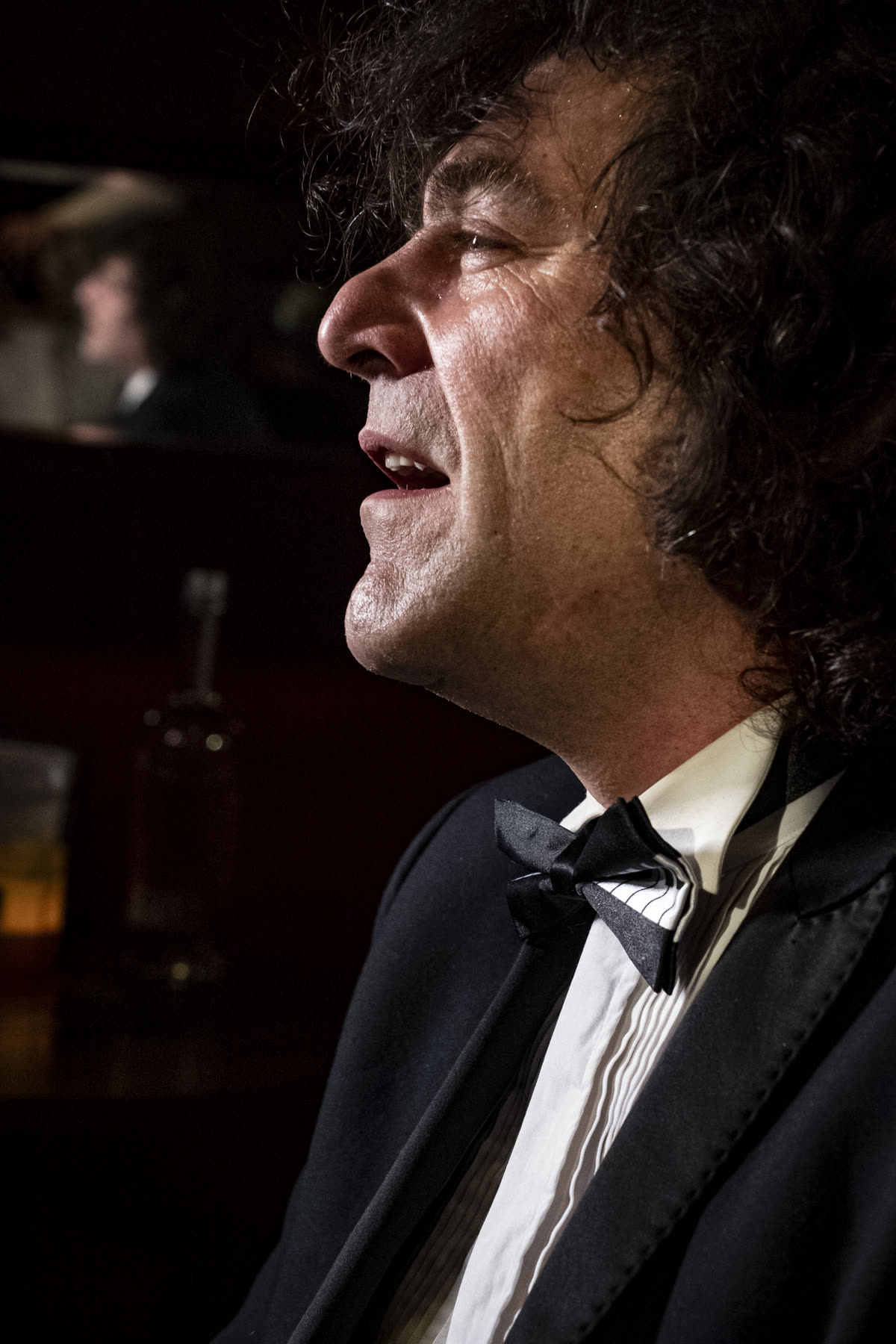 Robin Finesilver in profile, lit by candlelight in a Prague lounge