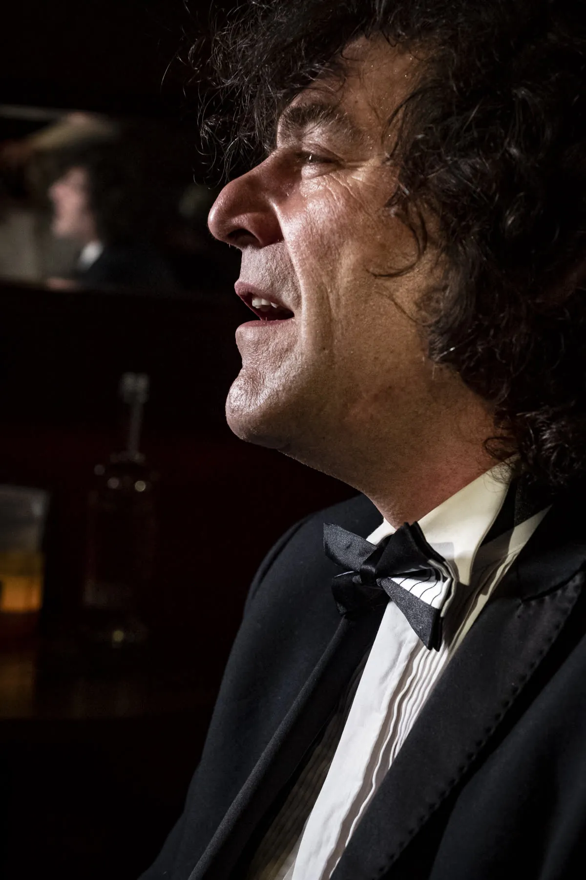 Robin Finesilver in profile, lit by candlelight in a Prague lounge